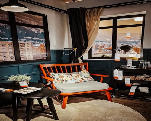 Cozy room ambiance with warm lamp light and comfortable chair